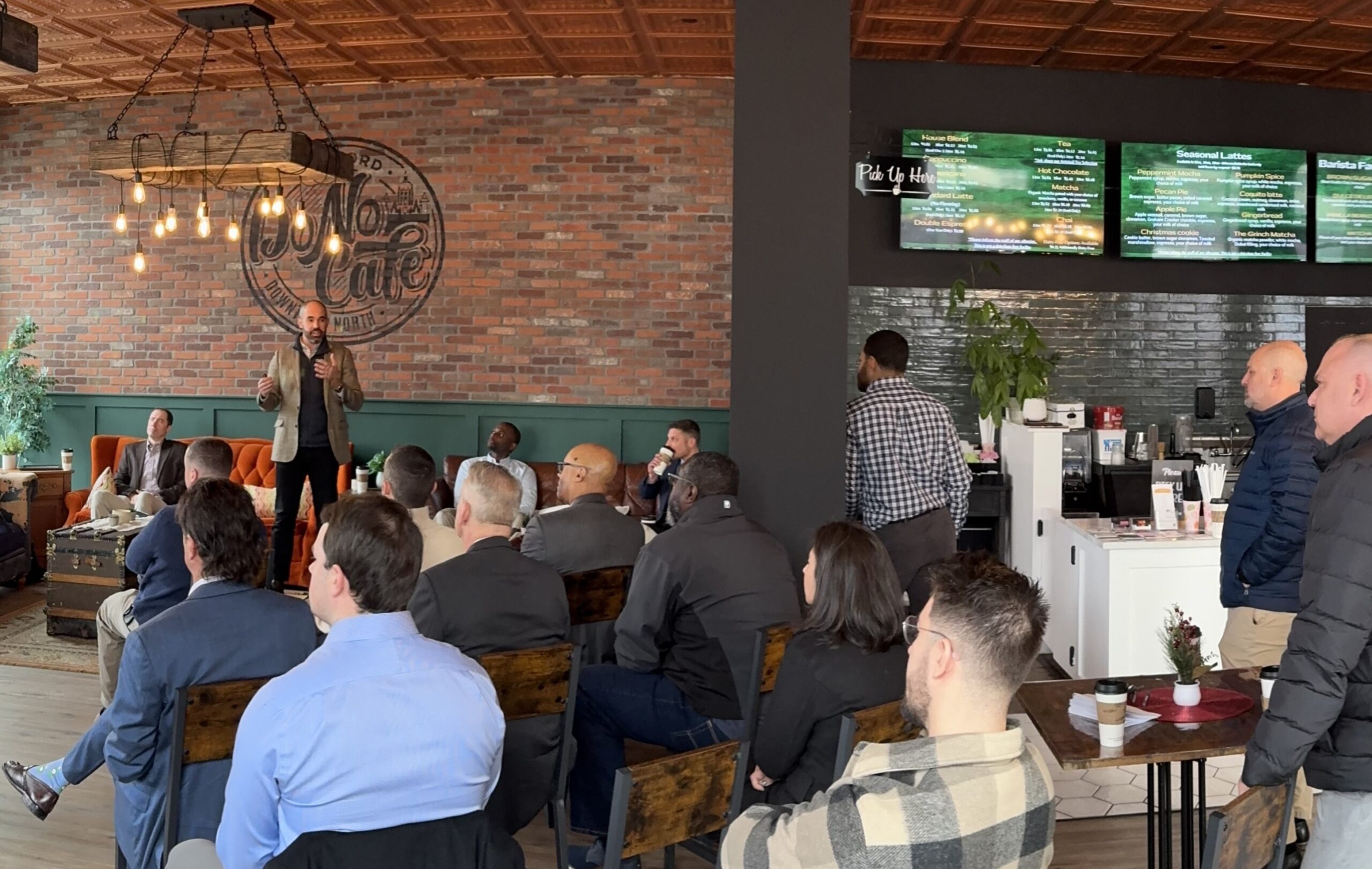 Attorney Aaron Frankel giving a talk to an audience in a coffee shop