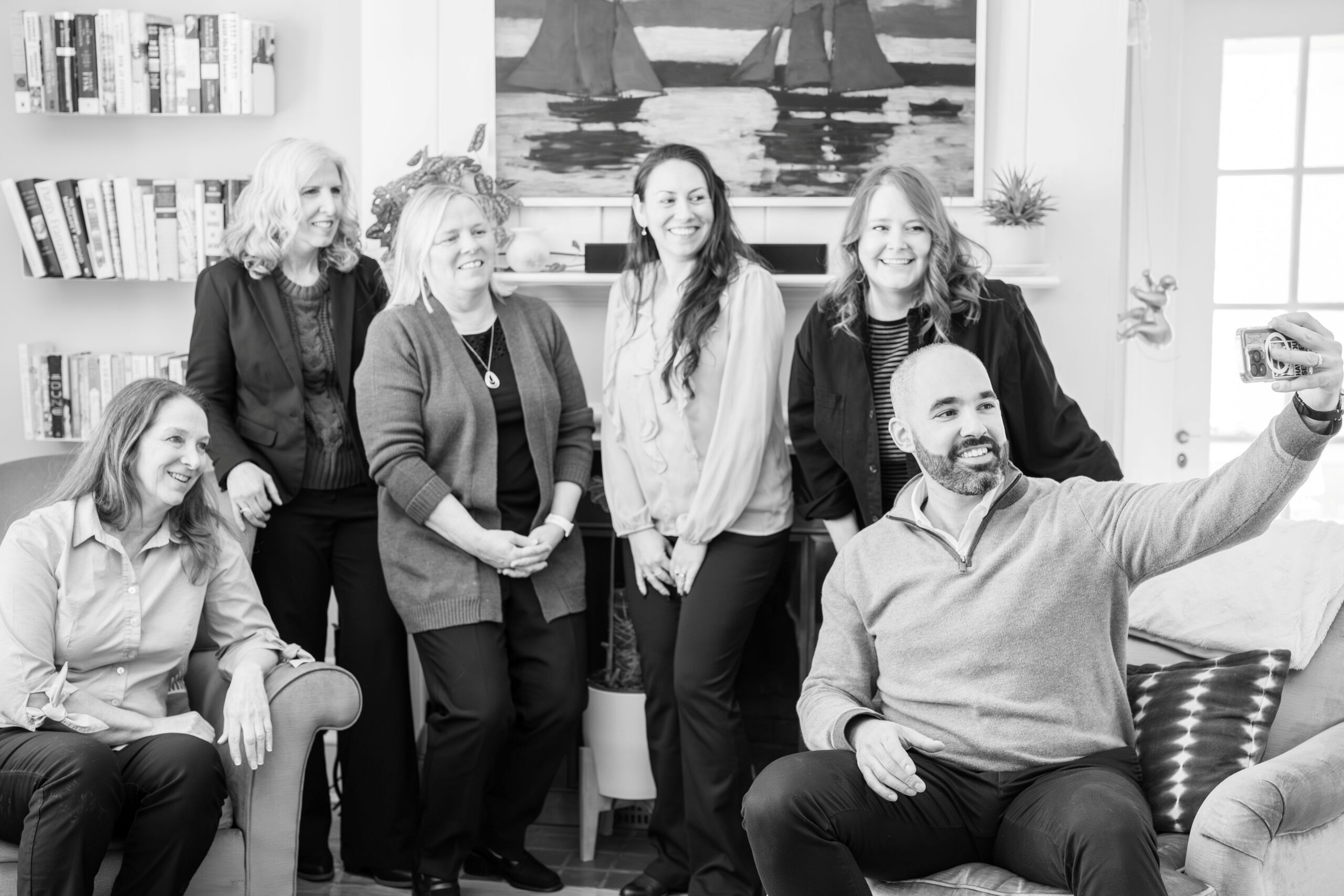 black and white photo of the whole Franklin & Frankel team taking a selfie.