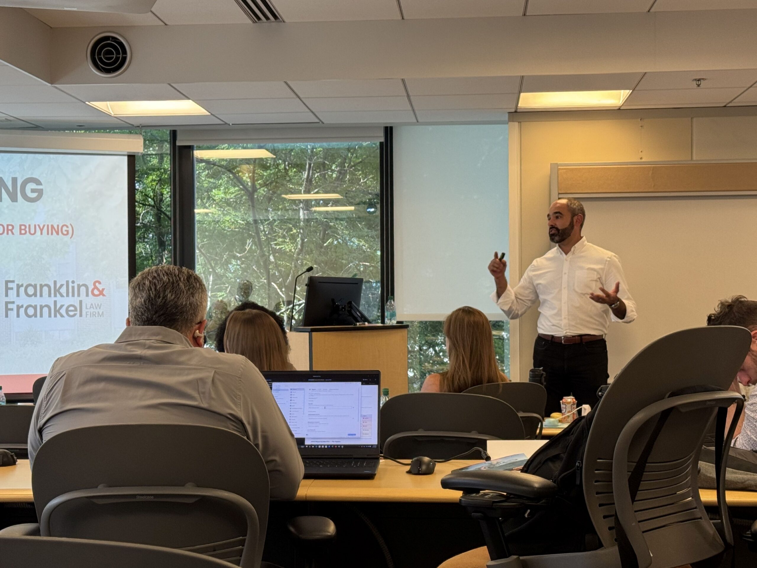Attorney Aaron Frankel speaking to a group of business owners